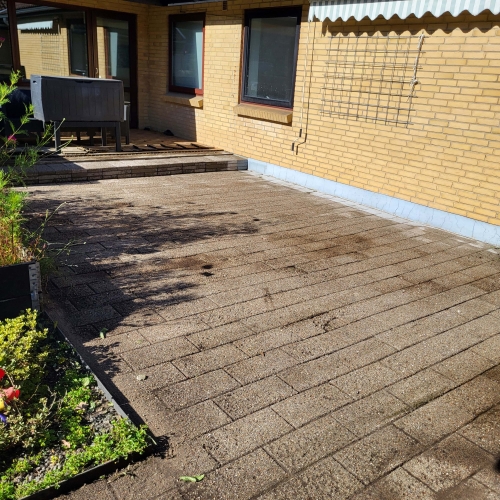 fliserensning af terrasse ved husmur